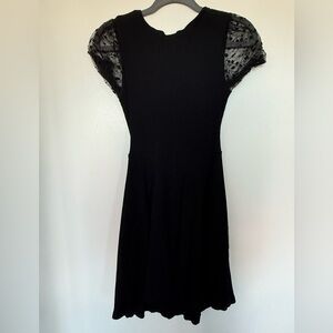 Elegant Black Dress with Sheer Polka Dot Sleeves
